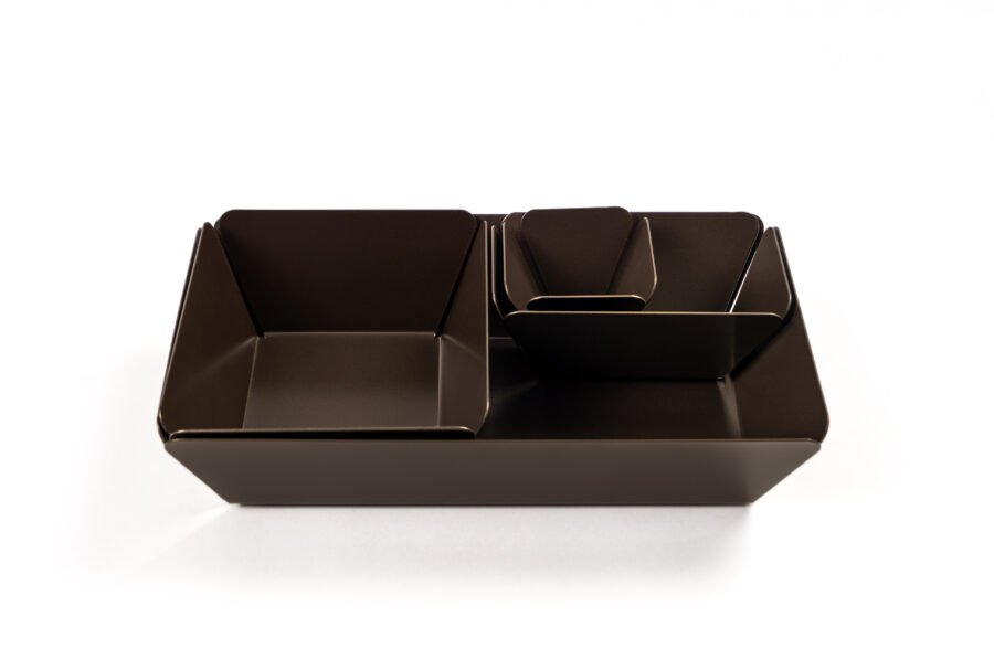 Set of four stainless steel Nesting Trays in tall, shallow, and tapered designs.
